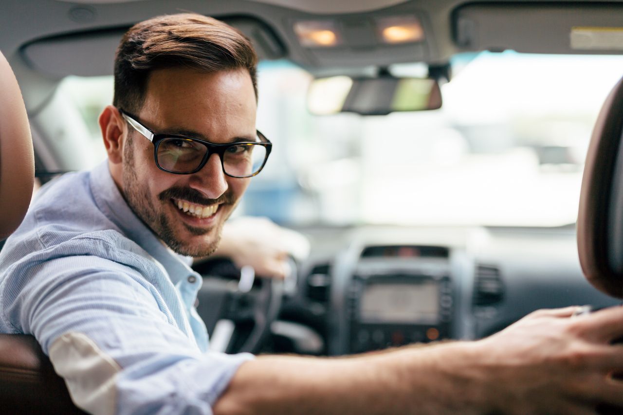 Handsome businessman driving a car to work